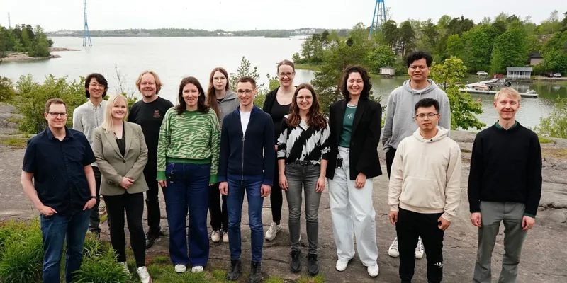 Members of the Machine Learning in Biomedicine group standing together outside Biomedicum Helsinki